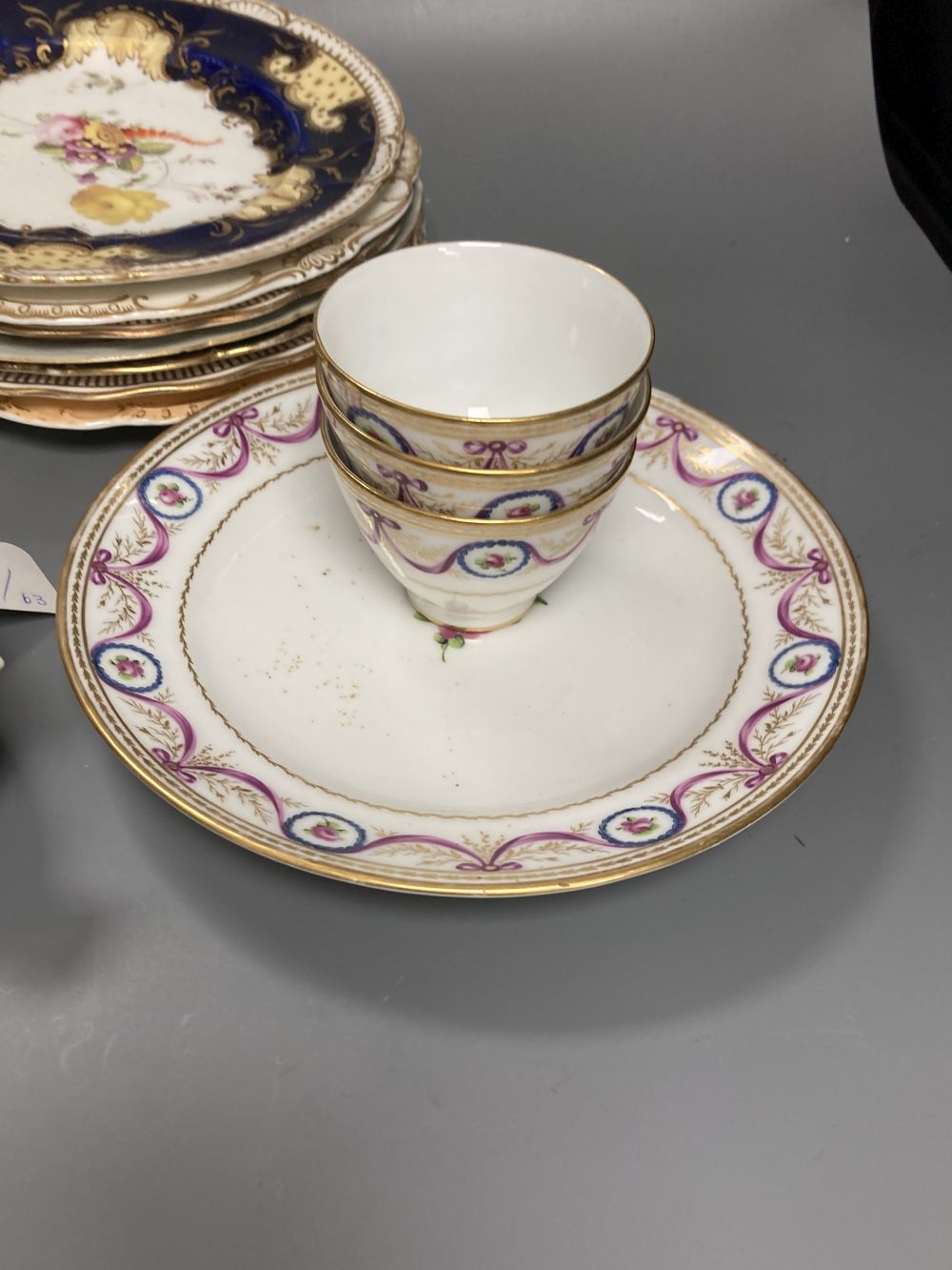 A Worcester Kakiemon vase, c.1765, a 19th century Paris porcelain plate and three tea bowls and 19th century English porcelain plates e